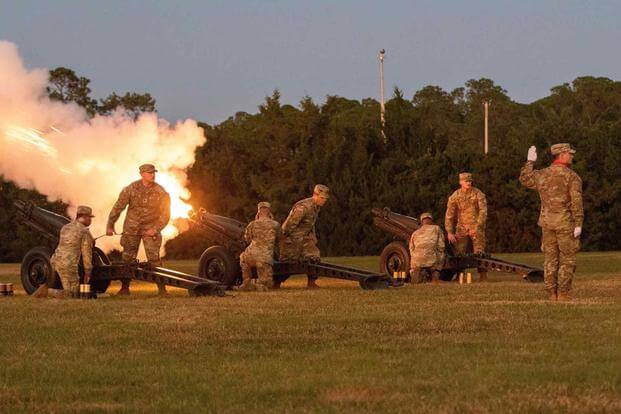 Soldiers fire a cannon during "Twilight Tattoo"
