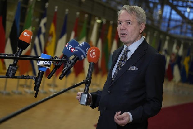 Finland's Foreign Minister Pekka Haavisto speaks with the media as he arrives at a meeting