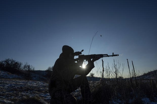 "Sirko", a Ukrainian serviceman of Karpatska Sich battalion tests his AK-74 rifle