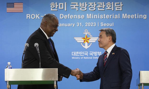 U.S. Secretary of Defense Lloyd Austin, left, shakes hands with South Korean Defense Minister Lee Jong-sup