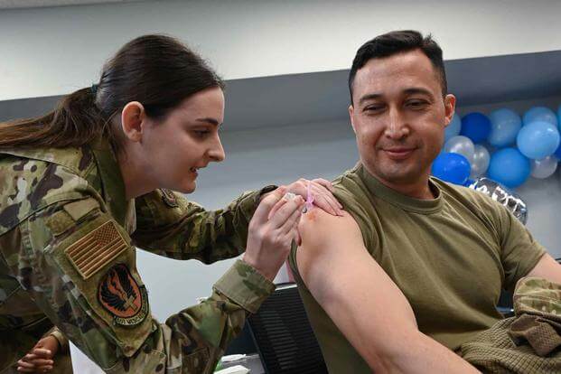 A technician administers a vaccine at Tinker Air Force Base.