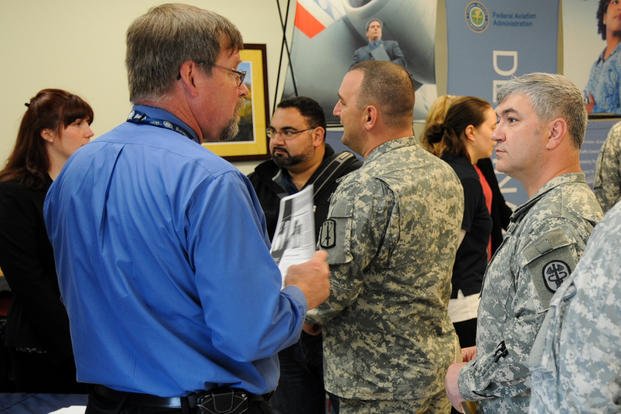 Soldiers assigned to the Warrior Transition Battalion at Joint Base Lewis-McChord, Washington, speak with federal agency representatives during the Operation Warfighter Internship Fair.