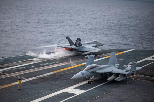 An F/A-18E Super Hornet launches from the aircraft carrier USS Nimitz.