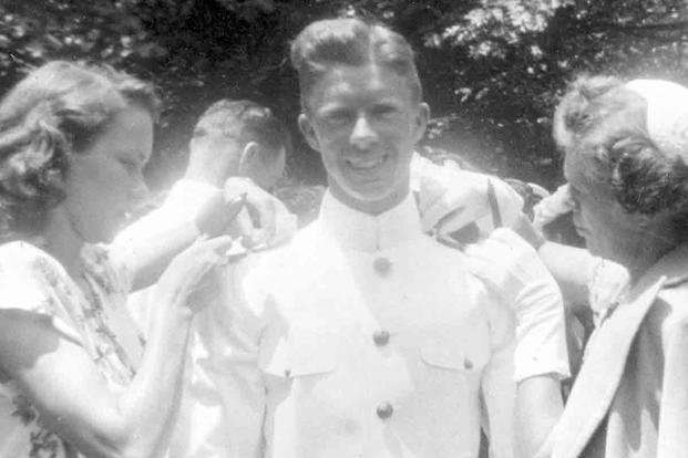 Jimmy Carter's wife, Rosalynn, and his mother, Lillian, pin ensign bars on his epaulets after his graduation from the U.S. Naval Academy in 1946. 