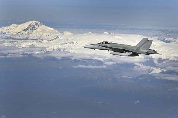 A Canadian CF-18 Hornet flies over Alaskan airspace.