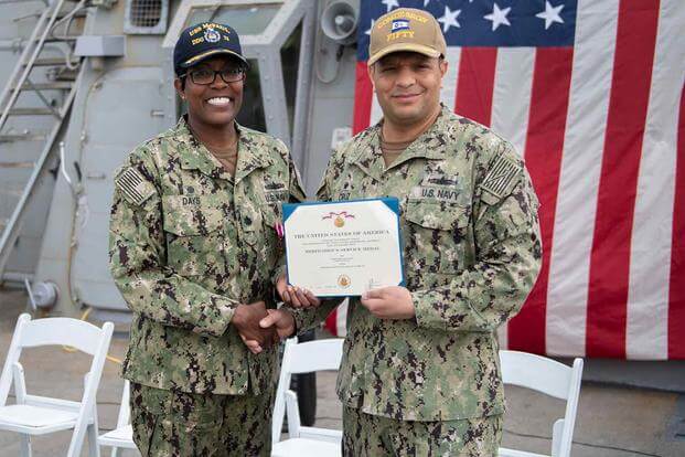 Cmdr. Janet Days receives a meritorious service medal.