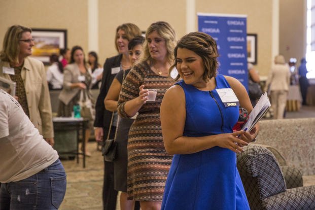 Amanda Wilcox, a military spouse and speaker at the 10th military Spouse Symposium, "Keeping a Career on the Move," mingles with symposium attendees prior to the opening remarks of the event at the Marston Pavilion aboard Marine Corps Base Camp Lejeune.