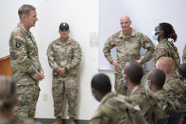 Chief of Staff of the Army Gen. James McConville listens to Daysia Holiday