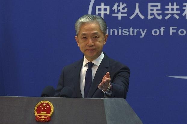 Chinese Foreign Ministry spokesperson Wang Wenbin gestures during a media briefing