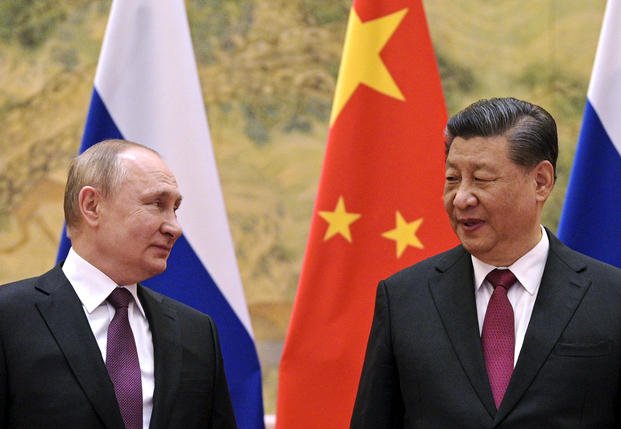Chinese President Xi Jinping, right, and Russian President Vladimir Putin talk to each other