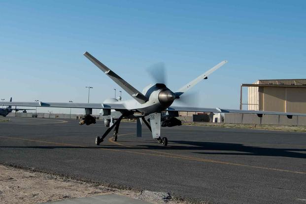 An MQ-9 Reaper turns out of a parking ramp.