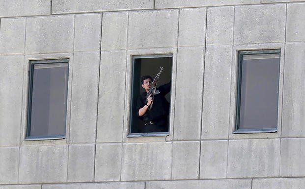armed man stands in a window of the parliament building during an attack by militants in Tehran, Iran