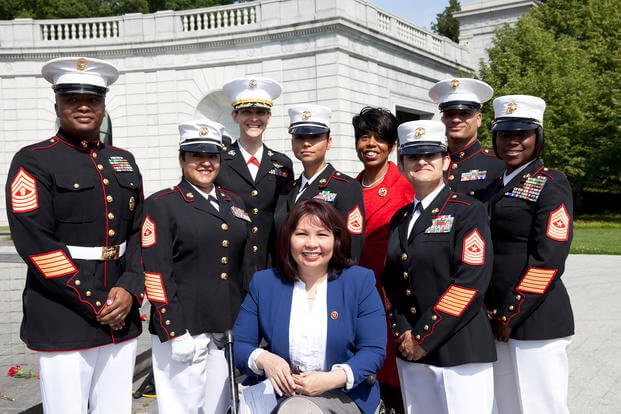 U.S. Marines pose with guests during the 17th annual wreath-laying ceremony at the Women In Military Service for America Memorial, Arlington, Virginia.