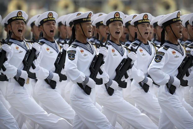 Soldiers from China's PLA Navy march in formation.