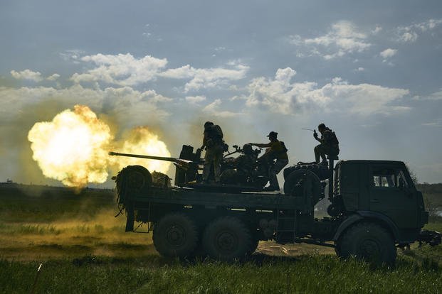Ukrainian soldiers fire a cannon near Bakhmut