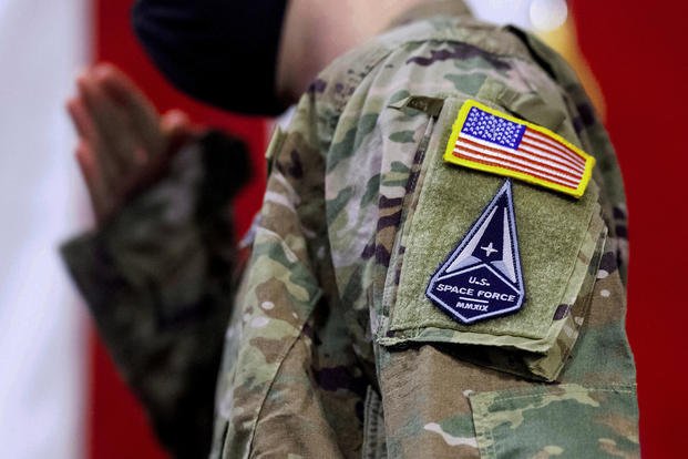 - An Air Force specialist salutes in a U.S. Space Force uniform.