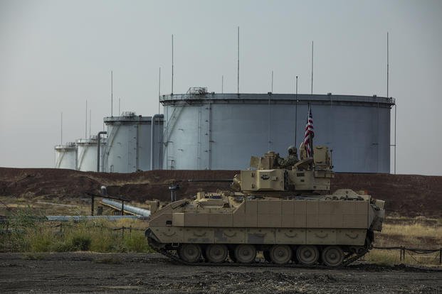 A M2 Bradley, with Alpha Troop, 1st Battalion, 6th Infantry Regiment, 2nd Armored Brigade Combat Team, 1st Armored Division, scans for threats near an oil refinery in Northeast Syria.