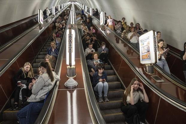 People take cover at a metro station during a Russian rocket attack in Kyiv, Ukraine.