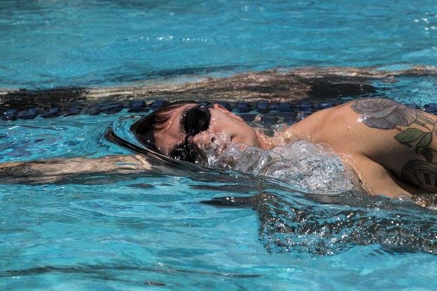 U.S. Navy sailors compete in the 500-yard timed swim event of the Naval Special Warfare (NSW) physical screening test at Naval Air Station Sigonella, Italy.