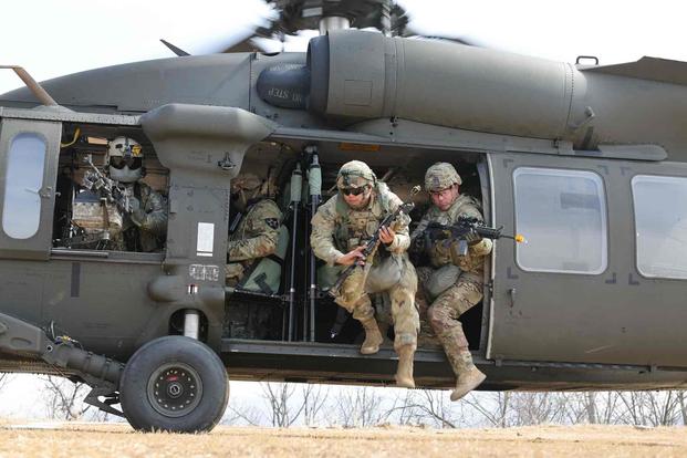 Soldiers exit a UH-60M Blackhawk helicopter