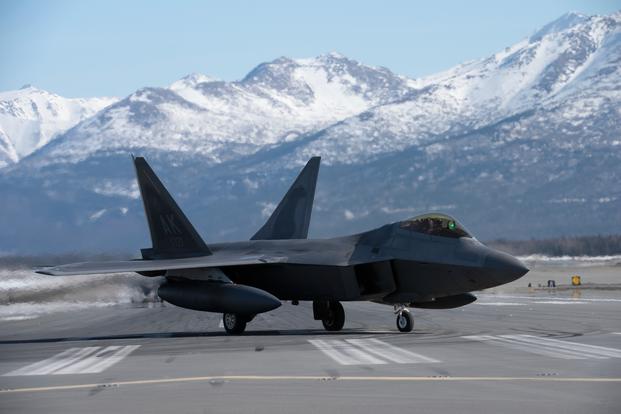 Twenty-four F-22 Raptors from 3rd Wing and 477th Fighter Group, a C-17 Globemaster III and an E-3 Sentry participate in a close formation taxi, known as an Elephant Walk, March 26, 2019, during a Polar Force exercise at Joint Base Elmendorf-Richardson, Alaska.