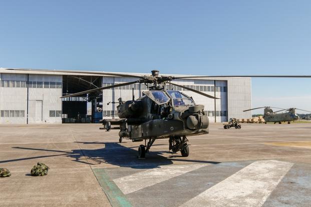 An AH-64D Apache helicopter sits on the flight line as Lt. Col. Lee Robinson, commander of the 603rd Aviation Support Battalion, 3rd Combat Aviation Brigade, 3rd Infantry Division completes his final flight at Hunter Army Airfield, Georgia, May 6.