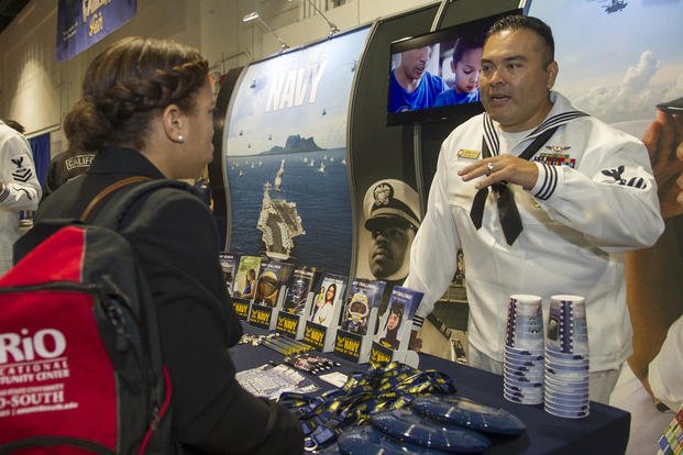Navy Counselor 1st Class Marcus Arocha, a recruiter assigned to Navy Talent Acquisition Force Mid-South, speaks to a potential future sailor during the Classic College and Career Fair in Memphis, Tenn.