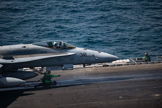 An F/A-18C Hornet prepares to launch off of the flight deck of the aircraft carrier USS Dwight D. Eisenhower