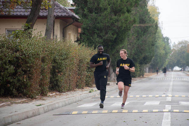 U.S. Army Sgt. Brandon Green and Spc. Fiona MacReynolds perform the 2-mile run exercise of the Army Combat Fitness Test at Mihail Kogalniceanu Air Base, Romania.