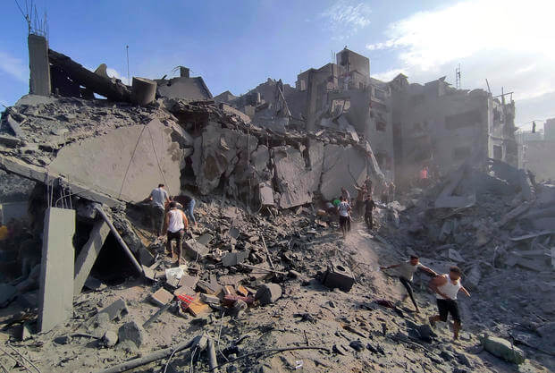 Palestinians inspect the damage of buildings destroyed by Israeli airstrikes on Jabaliya refugee camp