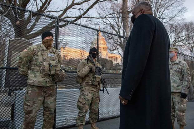 Secretary of Defense Lloyd J. Austin III speaks with National Guardsmen