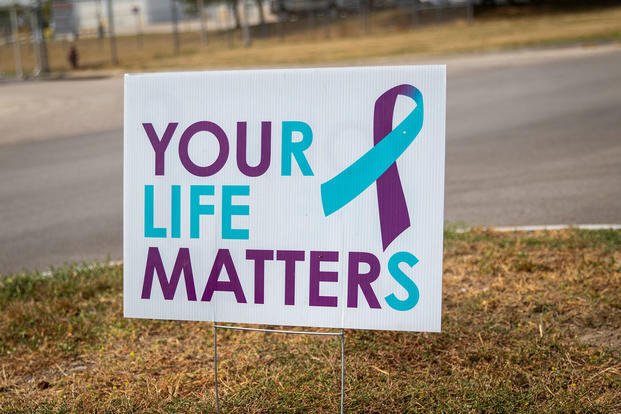 A sign reading "Your Life Matters" is seen at the entrance to the Nebraska National Guard air base