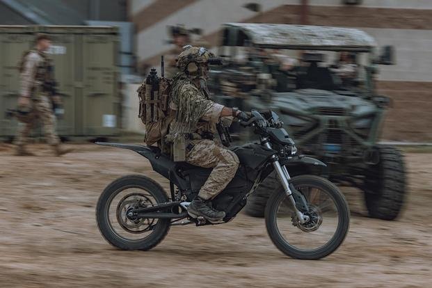 A U.S. Marine assigned to Reconnaissance Company, 15th Marine Expeditionary Unit, rides an MMX motorcycle en route to a raid site during the ground interoperability exercise at Marine Corps Base Camp Pendleton, California.