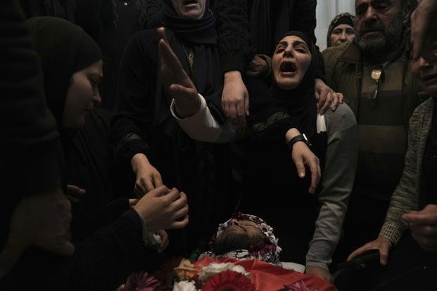 Relatives mourn 17-year-old American Tawfiq Ajaq at his funeral. 