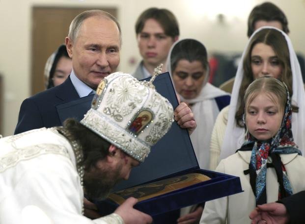 Russian Orthodox Archbishop of Odintsovo and Krasnogorsk Foma kisses an icon.