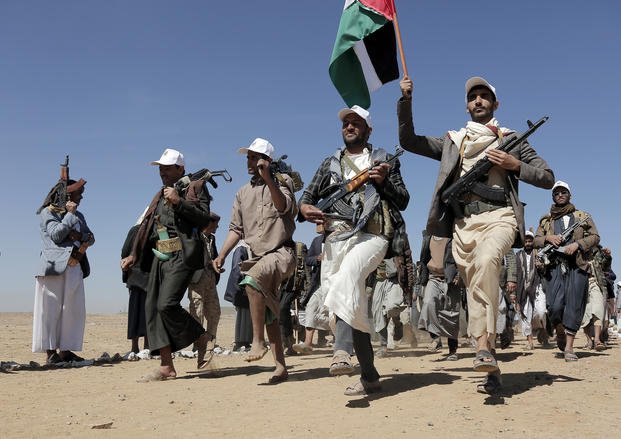 Houthi fighters march during a rally of support for the Palestinians in the Gaza Strip and against the U.S. strikes on Yemen outside Sanaa