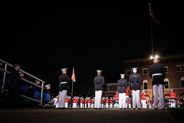 The Box and Staff representing Marine Barracks Washington (MBW) take their place as the U.S. Marine Corps Drum & Bugle Corps performs during an evening parade at MBW, Washington, D.C.