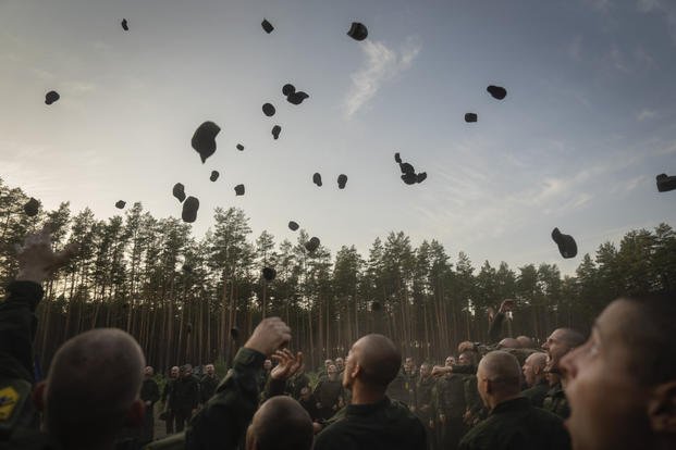 Newly recruited soldiers celebrate the end of their training at a military base