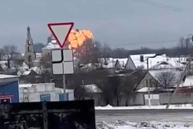 flames rising from the scene of a warplane crashed at a residential area near Yablonovo, Belgorod region
