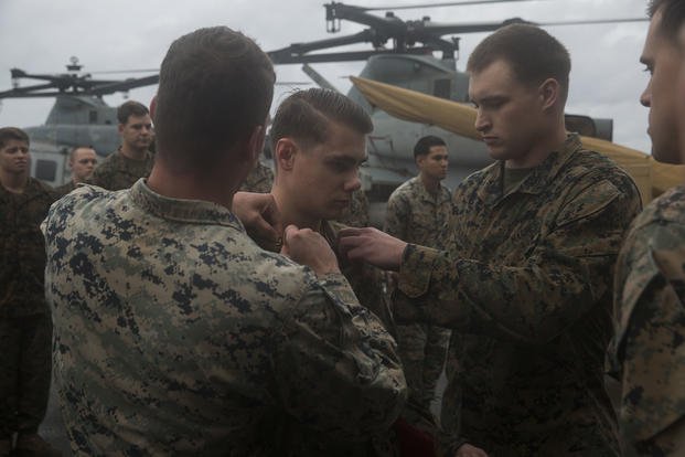 U.S. Marine Lance Cpl. Brice Robinson, a chemical, biological, radiological, nuclear defense specialist with Battalion Landing Team 3/1, 13th Marine Expeditionary Unit (MEU), is promoted to the rank of corporal aboard the San Antonio-class amphibious transport dock USS Anchorage (LPD 23) while on a deployment of the Essex Amphibious Ready Group (ARG) and 13th MEU to the South China Sea.