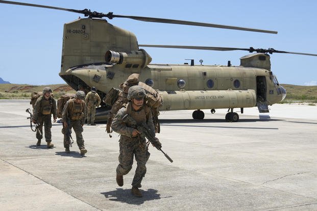 U.S. troopers alight from a U.S. Army CH-47 carrying American and Philippine troops