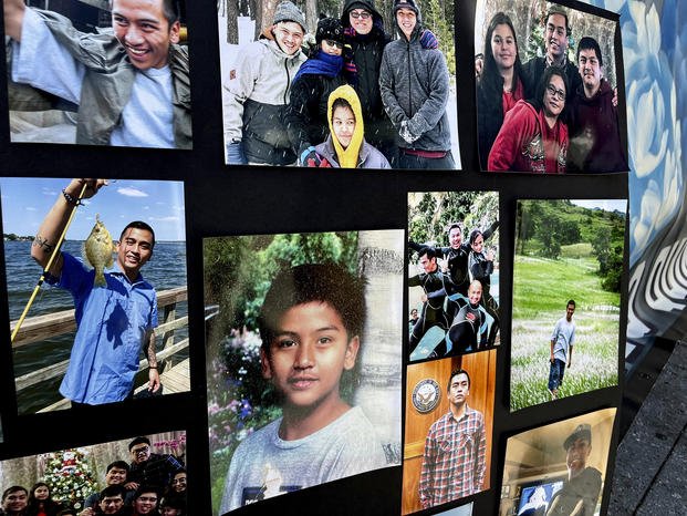 Photos of Angelo Quinto are displayed during a news conference