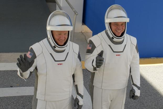 NASA astronauts Douglas Hurley, left, and Robert “Bob” Behnken, wearing SpaceX spacesuits, are pictured during a dress rehearsal prior to the Demo-2 mission launch, May 23, 2020, at NASA’s Kennedy Space Center in Florida.
