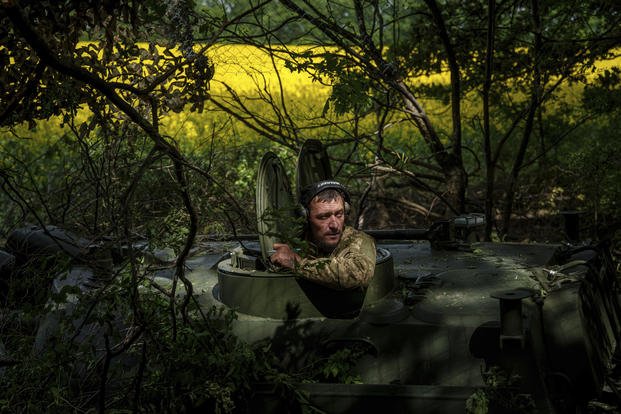 A Ukrainian soldier waits for an order for his artillery vehicle to open fire.