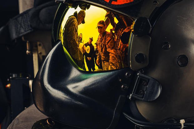 U.S. Army Reserve Flight Medics with the 7-158th Aviation, seen in the visor’s reflection