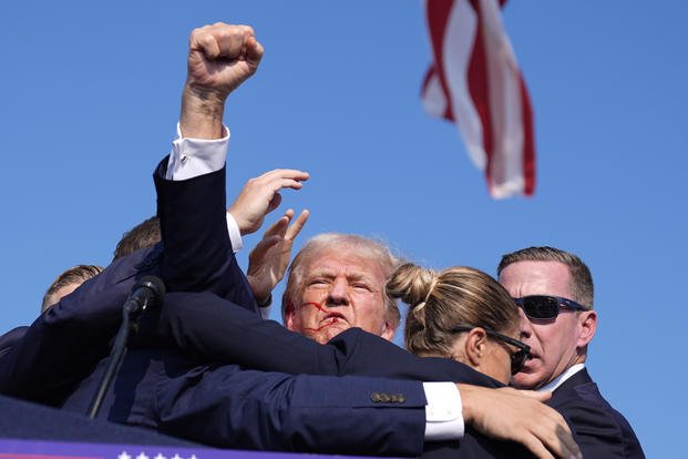 Secret Service whisks former President Donald Trump off stage.