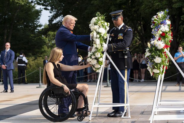 Former U.S. Marine Corps Cpl. Kelsee Lainhart left, and Republican presidential nominee former President Donald Trump