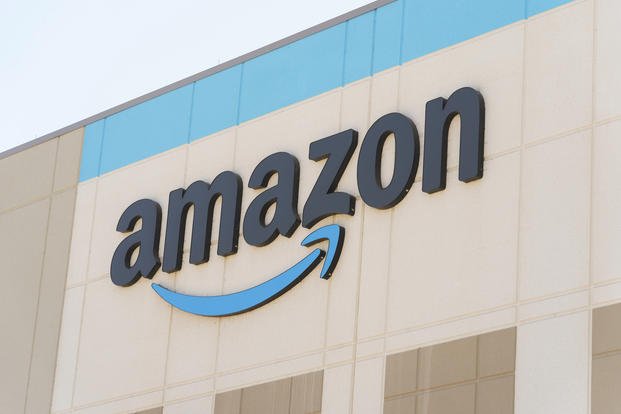 The Amazon logo is seen on the exterior wall of the Amazon OXR1 fulfillment center in Oxnard, Calif.