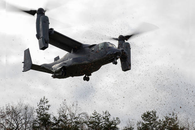 A CV-22B Osprey from the 21st Special Operations Squadron flies low over the trees as it prepares to land during exercise Resolute Dragon 21 at the Ojojihara Training Area, Japan.