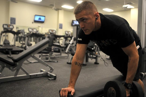 Senior Airman Kyle Honeycutt performs one-arm dumbbell rows in the Predator Fitness Center at Creech Air Force Base, Nev.